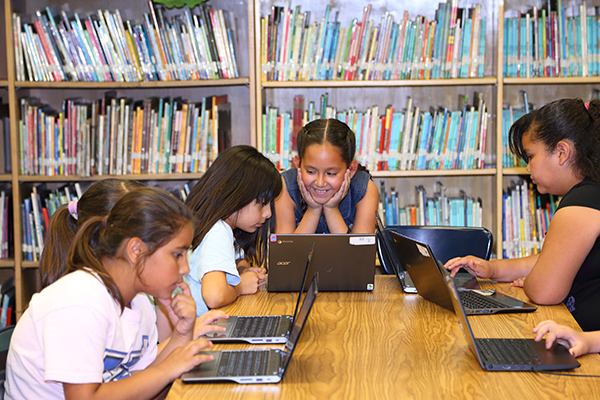 Children learning how to code at the library